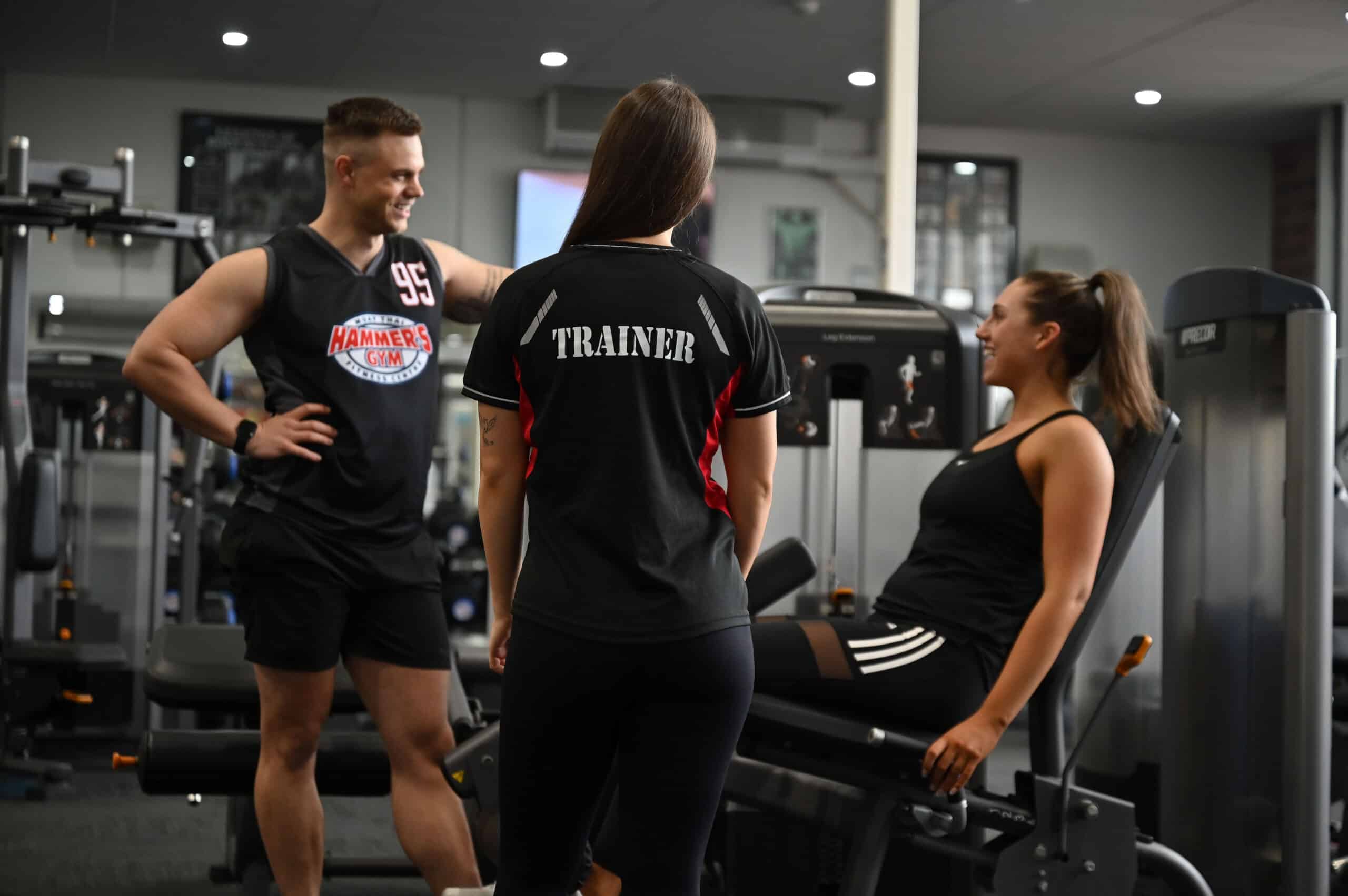 Hammer's Gym trainers talking with a member on the gym floor in Nunawading